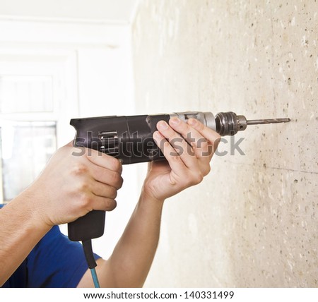 use Electric drill to drill the concrete wall