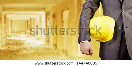 engineer yellow helmet for workers security over empty old building inside warehouse background  Copy Space for inscription