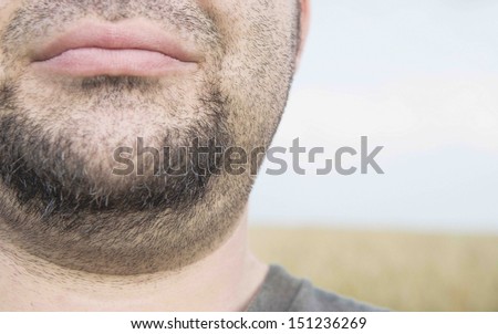 Closeup portrait of a beautiful male model against beach background No eyes