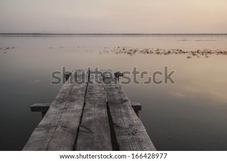 background of wooden landing stage on cloudy sunset sky with horizon skyline