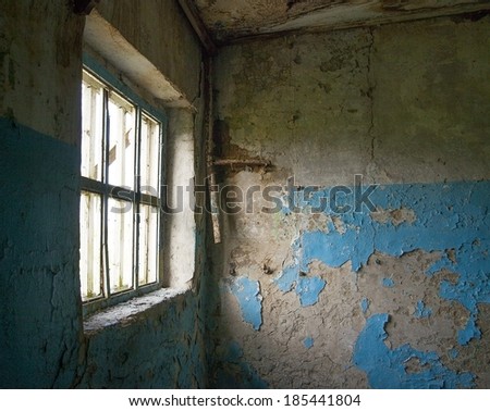 Background of image desolate old industrial building blue painting abandoned room inside Natural day light in wooden window frame