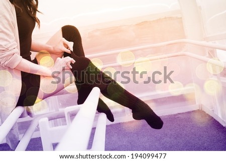 Unrecognizable person No face Woman legs in black pantyhose stockings indoor sits on a metal railing Copy space  Young adult girl wearing short dress and tightens a thin fingers woolen tights