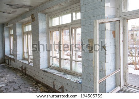 Background of brocken debris glass in opened wooden windows frame and blue tile wall