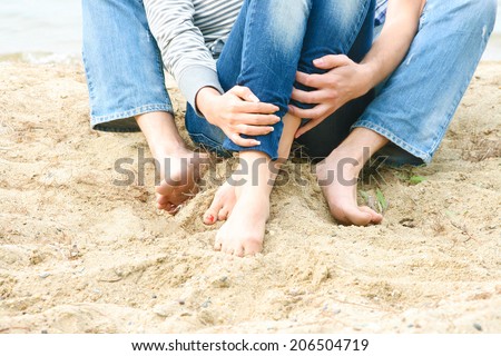 No face couple Foot and hands on textured yellow sand Unrecognizable person Copy space for inscription