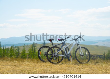 landscape with a couple of bike on sunny cloudy sky background . Copy space for inscription Empty copy space for inscription