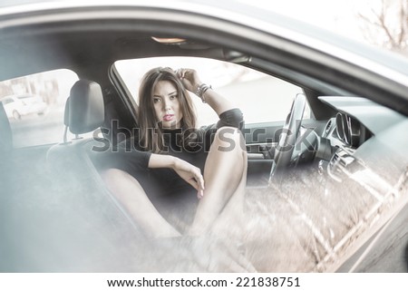 Portrait babe Young adult sexy brunette dreaming girl sitting in luxury black car and wait boyfriend Slim cute asian woman inside black leather chair auto open door with leg With reflection on window