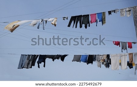 Image, Stock Photo Towels on clothesline between two trees on the campsite. In the background a caravan with awning.