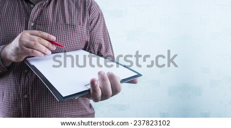 No face Unrecognizable person Businessman holding white texture empty list of paper and red pen Business man wearing stripped brown shirt Copy space for inscription on wallpaper structure