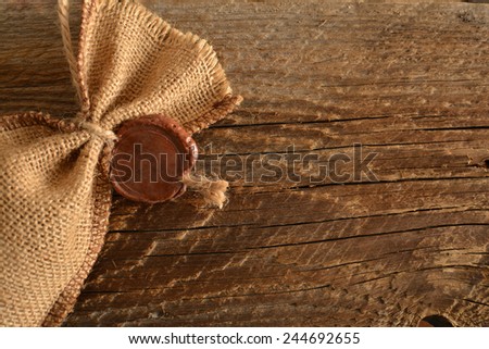 Backdrop of wax seal on sack cloth material on old retro vintage aged texture background Empty space for inscription