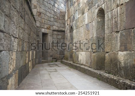 perspective street background between stones gray old retro block brick wall Decorative cross pattern Clean ground No people Empty space for inscription object or people Armenian orthodox church