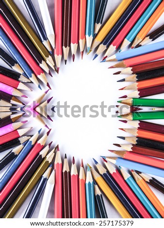 Empty space background of bunch of colored pencils on paper Idea of concentration and attraction to nucleus center circle radius unity concept of leadership, community, the team focused on one goal