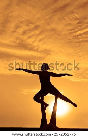 Similar – Image, Stock Photo Man doing acrobatic in the beach. Moody weather and rain