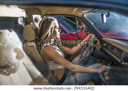 woman in car indoor keeps wheel looking at far away idea race driver Police blocked the road and headlights shining in the face Dusk light at the night