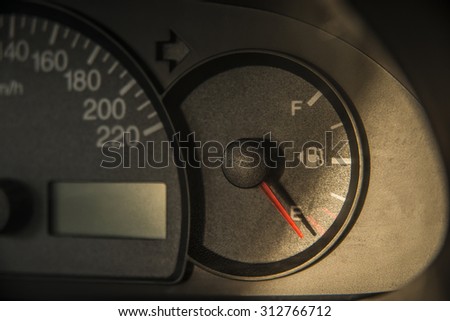 Scale of speed meter on car Auto rapprochement - at zero Sunset yellow light on black plastic texture Automobile inside interior