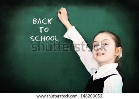 Education. Elementary school student at the blackboard. School concept - Back to School