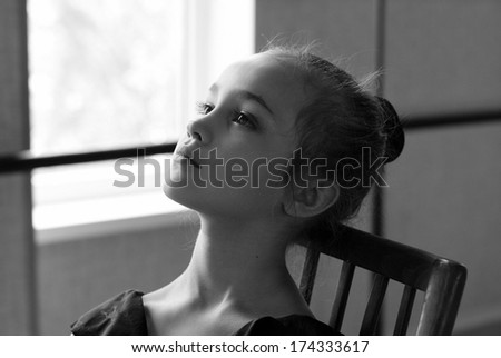 Portrait of young and beautiful ballet dancer in dance studio. Black and white art photo with bokeh and grain