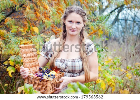 Beautiful woman with basket with fruit on the garden in summer. Healthy people. Healthy lifestyle