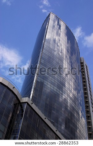 modern office tower with windows that working as pixel mirrored sky and clouds
