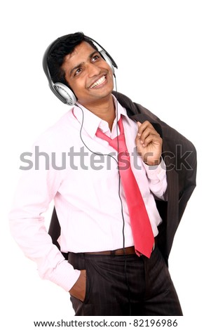 Indian business man hearing music isolated on white.