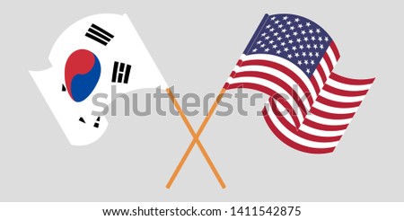 Crossed and waving flags of the USA and South Korea
