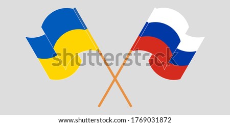 Crossed and waving flags of the Ukraine and Russia