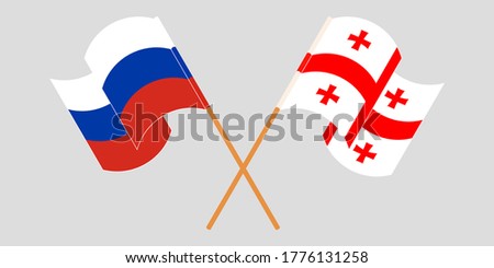 Crossed and waving flags of Georgia and Russia