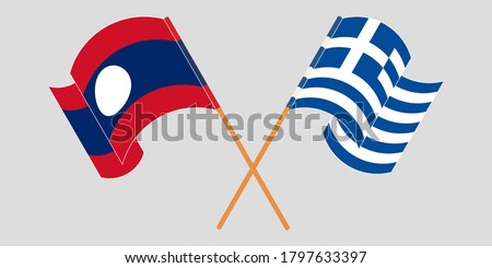 Crossed and waving flags of Laos and Greece