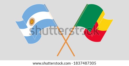 Crossed and waving flags of Benin and Argentina