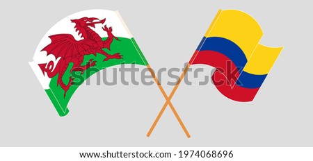 Crossed and waving flags of Wales and Colombia