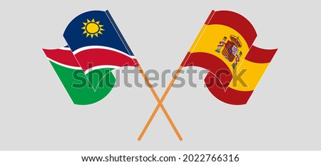 Crossed and waving flags of Namibia and Spain