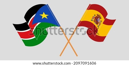 Crossed and waving flags of South Sudan and Spain. Vector illustration
