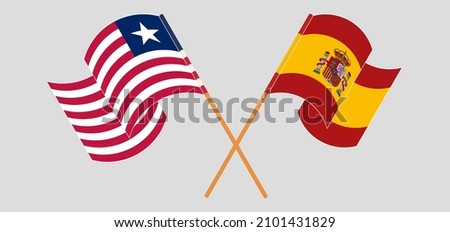 Crossed and waving flags of Liberia and Spain. Vector illustration
