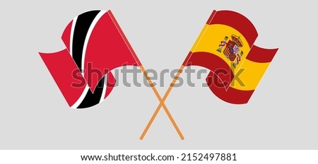 Crossed and waving flags of Trinidad and Tobago and Spain. Vector illustration
