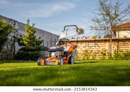 Lawn mover on green grass in modern garden. Machine for cutting lawns. Foto stock © 