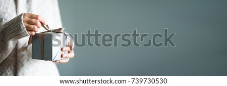 Similar – Image, Stock Photo female hands in winter gloves in a red and white striped hugging behind green Christmas tree outdoors. Christmas and New Year holiday concept