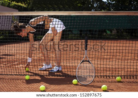 Young girl playing tennis on court, outside