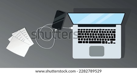View of the desktop from above, working on a laptop, charging the phone, documents are nearby. Flat vector illustration office in gray colors