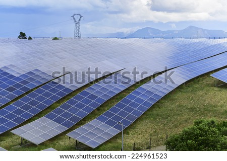 Solar energy power-plant, field of photovoltaic cells against stormy sky