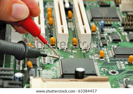 Technician in the service center testing electric circuit board