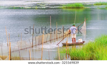 NINHBINH,VIETNAM - SEPTEMBER 26, 2015: Boats and fisherman in Van Long Natural reserve in Ninh Binh, Vietnam . Nature reserve Van Long Wetland in Viet Nam