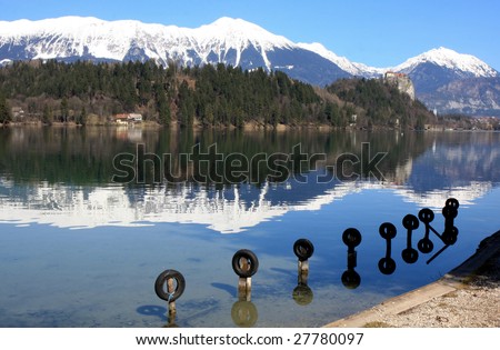 Alps Snow Reflection in Calm Lake with small Dock