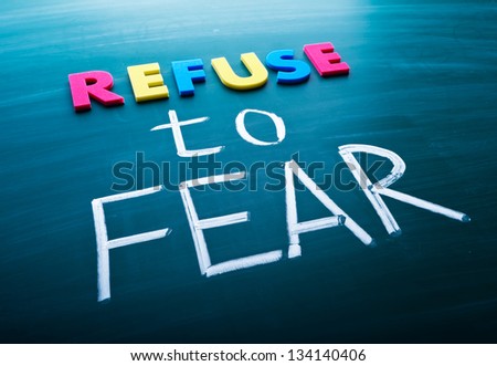 Refuse to fear, colorful conceptual words on blackboard.
