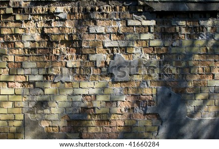 Old brick wall with the fallen off plaster, Background