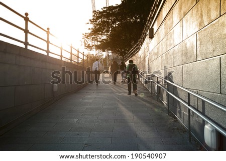 silhouette of people in the end of tunnel with back light in Singapore street