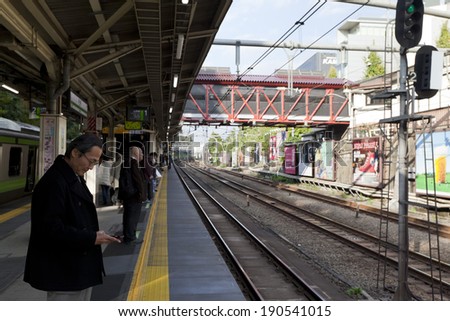 TOKYO - NOV 10 : Business man waiting for JR Lines in Iidabashi station on November 10, 2013 in Tokyo,Japan.