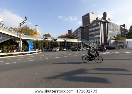 TOKYO - NOV 11  : Unidentified man riding bicycle on street near Harajuku train station on November 11,2013. Harajuku is known as a center of Japanese youth culture and fashion.