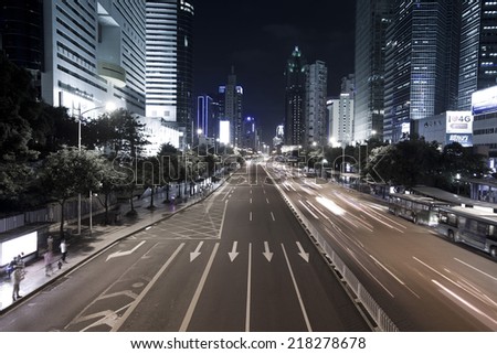SHENZHEN, CHINA - JULY 14 : Hi-rise building and vehicles commute at night time on July 14,2014 in Shenzhen, China. Shenzhen is China\'s financial center and first\'s special economic zone.