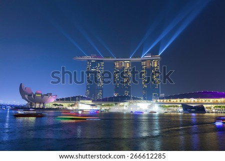 SINGAPORE - MAR 21 : Marina Bay Sands hotel light show at night on March 21,2015 in Singapore. It is the world\'s most expensive building with cost of US$ 4.7 billion and landmark of Singapore.