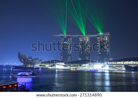 SINGAPORE - MAR 21 : Marina Bay Sands hotel light show at night on March 21,2015 in Singapore. It is the world\'s most expensive building with cost of US$ 4.7 billion and landmark of Singapore.