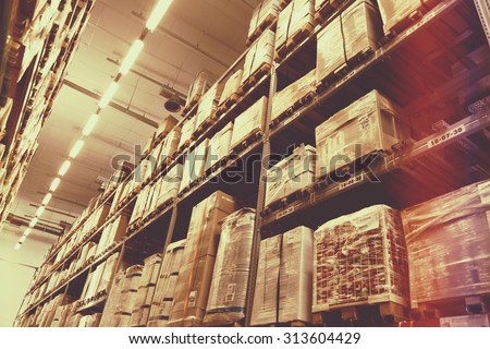 Rows of shelves with boxes in factory warehouse, light leak filter.